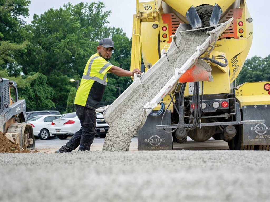 All Star Contracting Concrete Pouring 1 Worker Guiding Fresh Concrete From A Mixer Truck Chute.